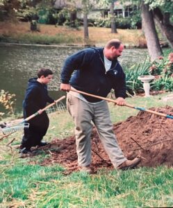 son and dad planting tree